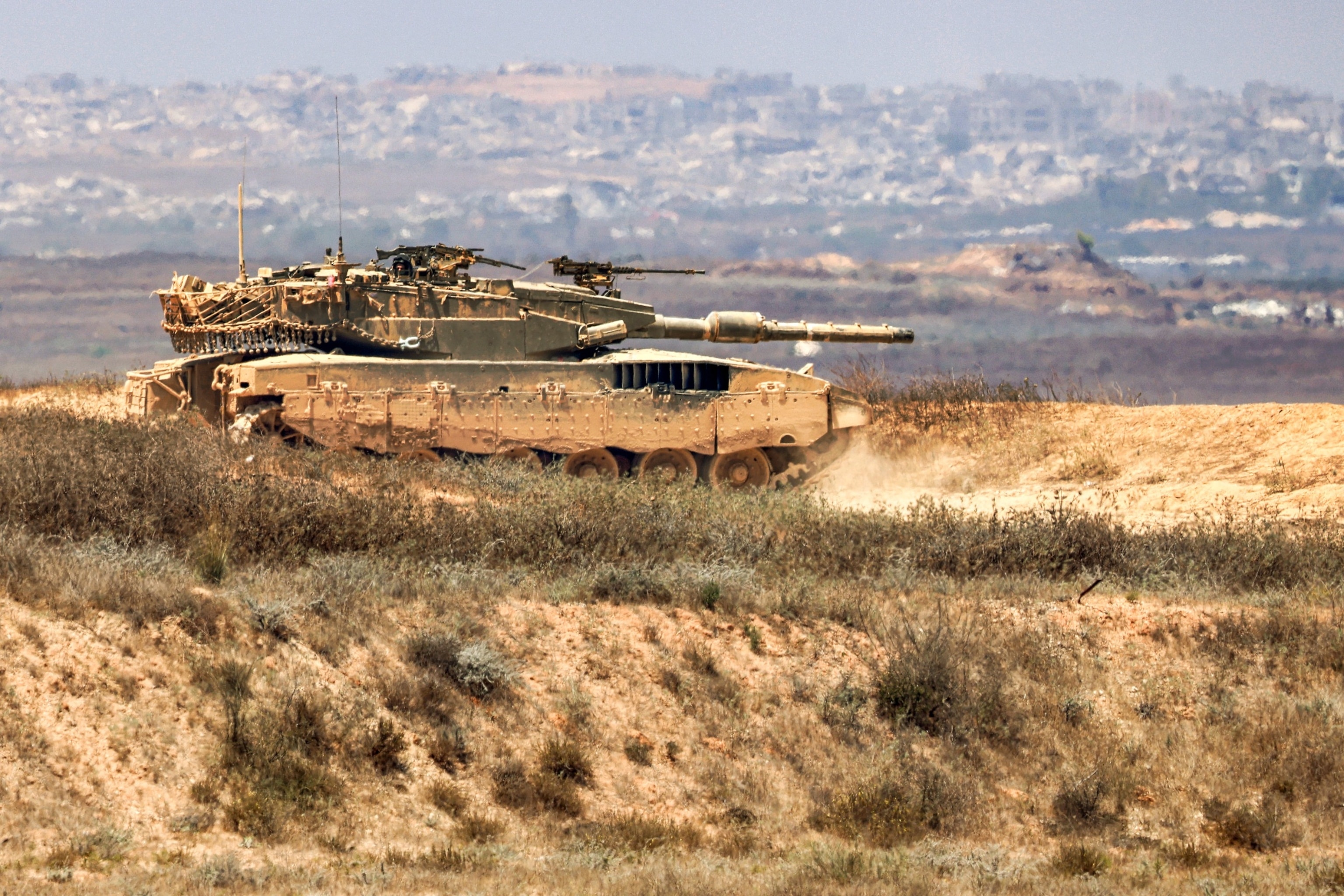 PHOTO: An Israeli army main battle tank moves along an area near the border with the Gaza Strip and southern Israel, July 2, 2024, amid the ongoing conflict in the Palestinian territory between Israel and Hamas. 