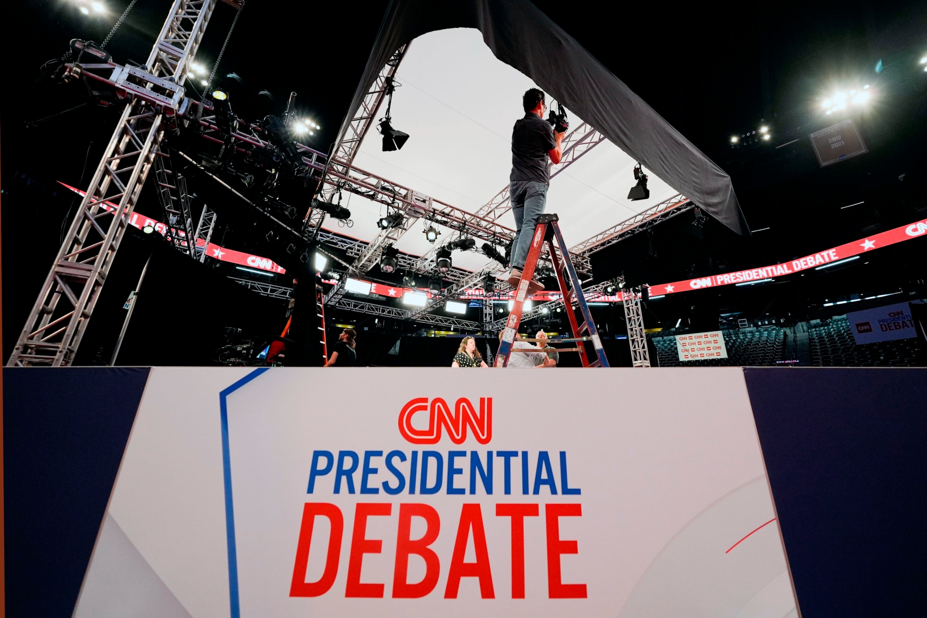 PHOTO: Ben Starett, lighting programmer for CNN, sets up lights in the spin room for the presidential debate between President Joe Biden and Republican presidential candidate former President Donald Trump in Atlanta,  June 26, 2024.